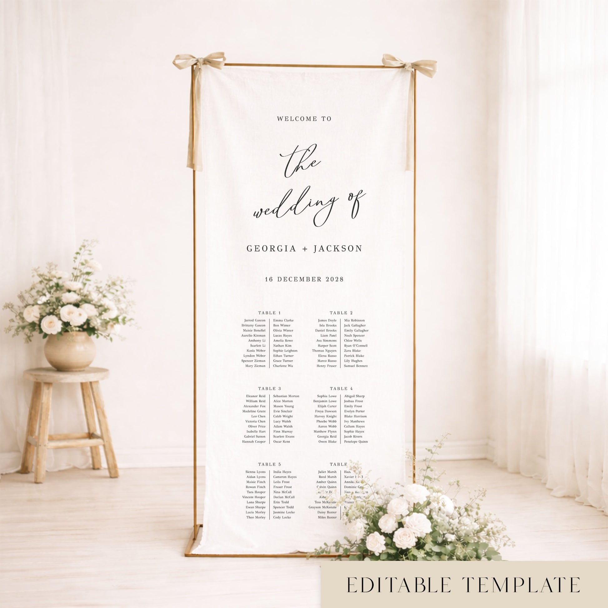 Gold frame with a hanging white linen wedding seating chart.