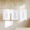 Three white seating chart cards with printed names, clipped to a string with pegs, against a neutral background.