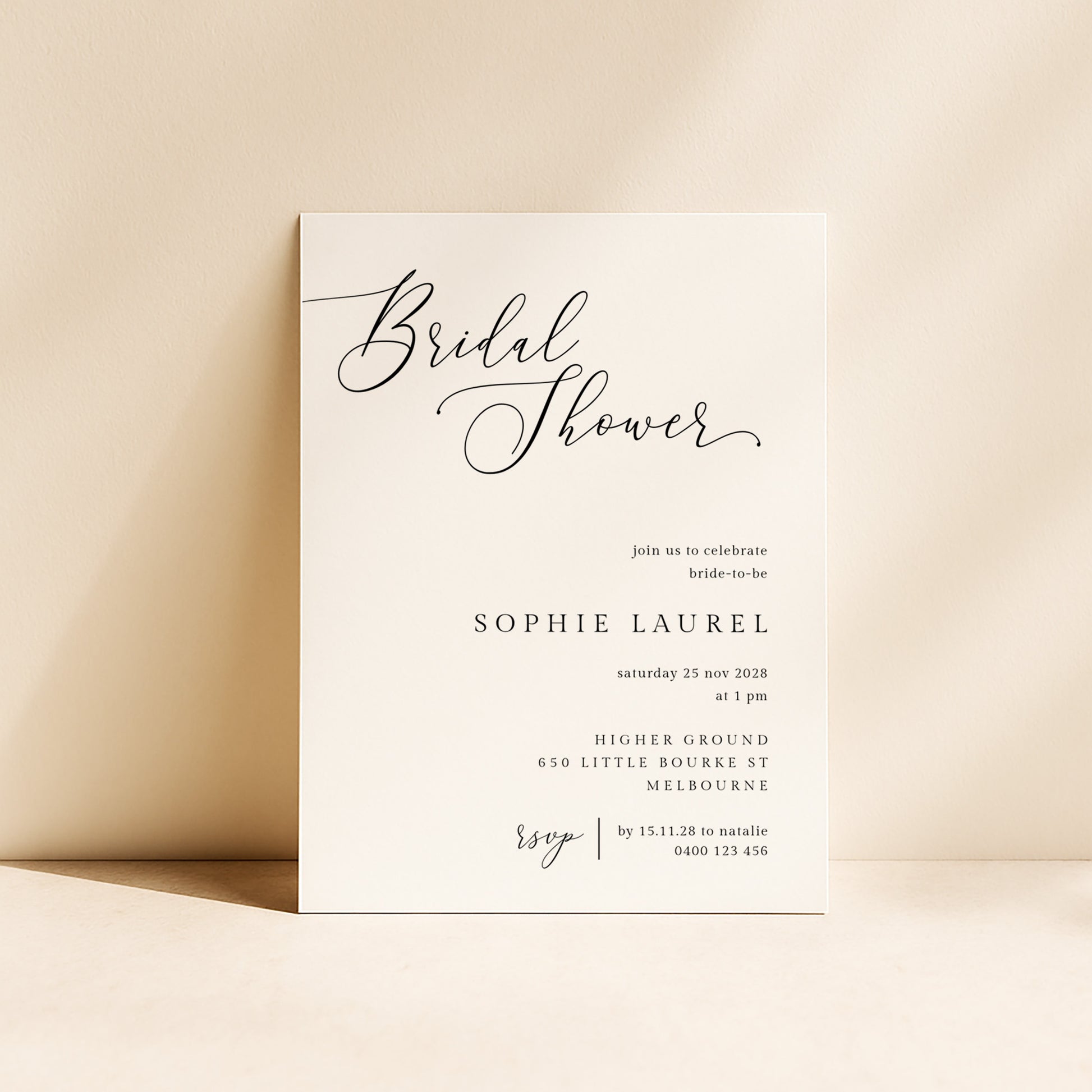 Modern bridal shower invitation card on a beige background.