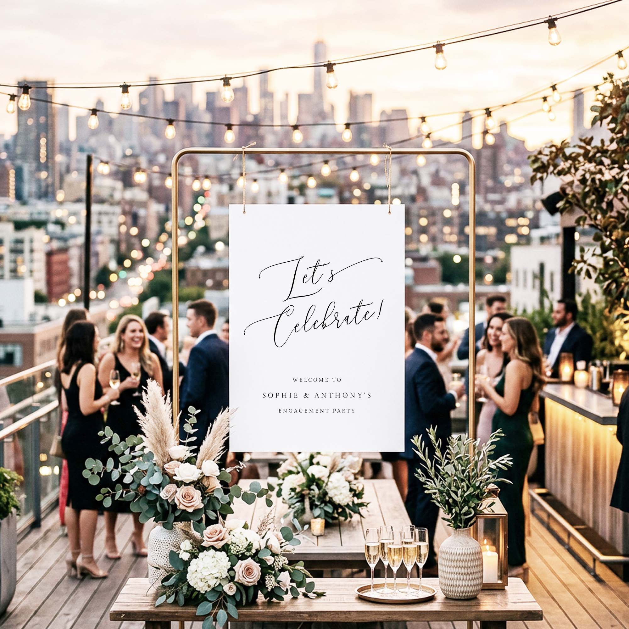 Engagement party sign on a gold frame at a rooftop party.