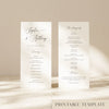 Two DL-sized wedding program cards standing upright on a textured surface with soft natural light creating shadows across the background.