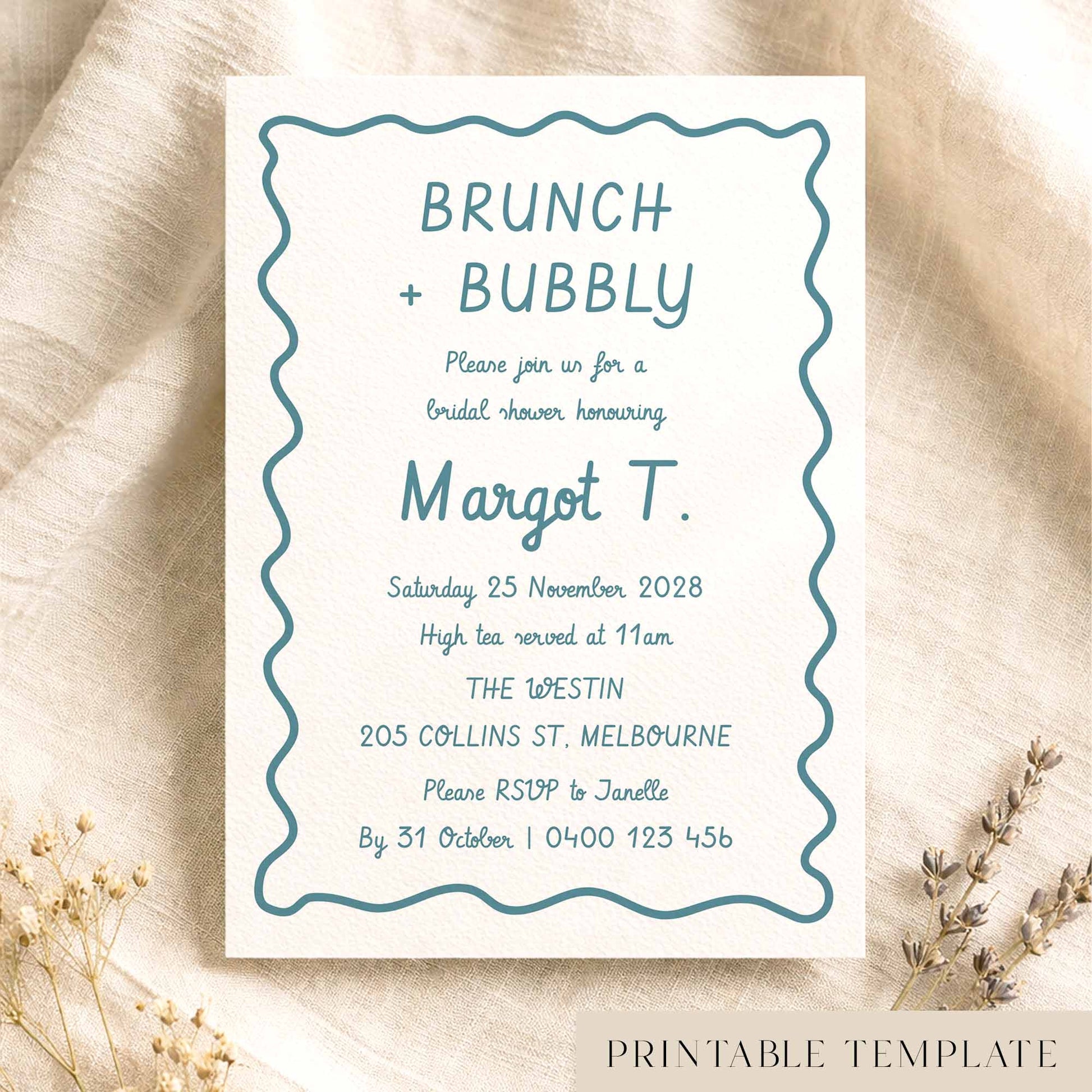Whimsical hand-drawn bridal shower invitation template on textured card on fabric background.