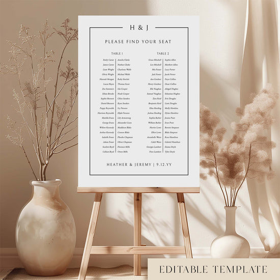 Modern long tables seating chart template on an easel with decorative vases and plants.