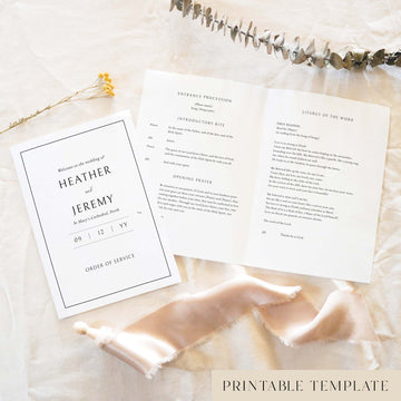 A5 wedding Mass ceremony booklet shown open with the cover beside it, styled on light fabric with dried florals and a soft ribbon.