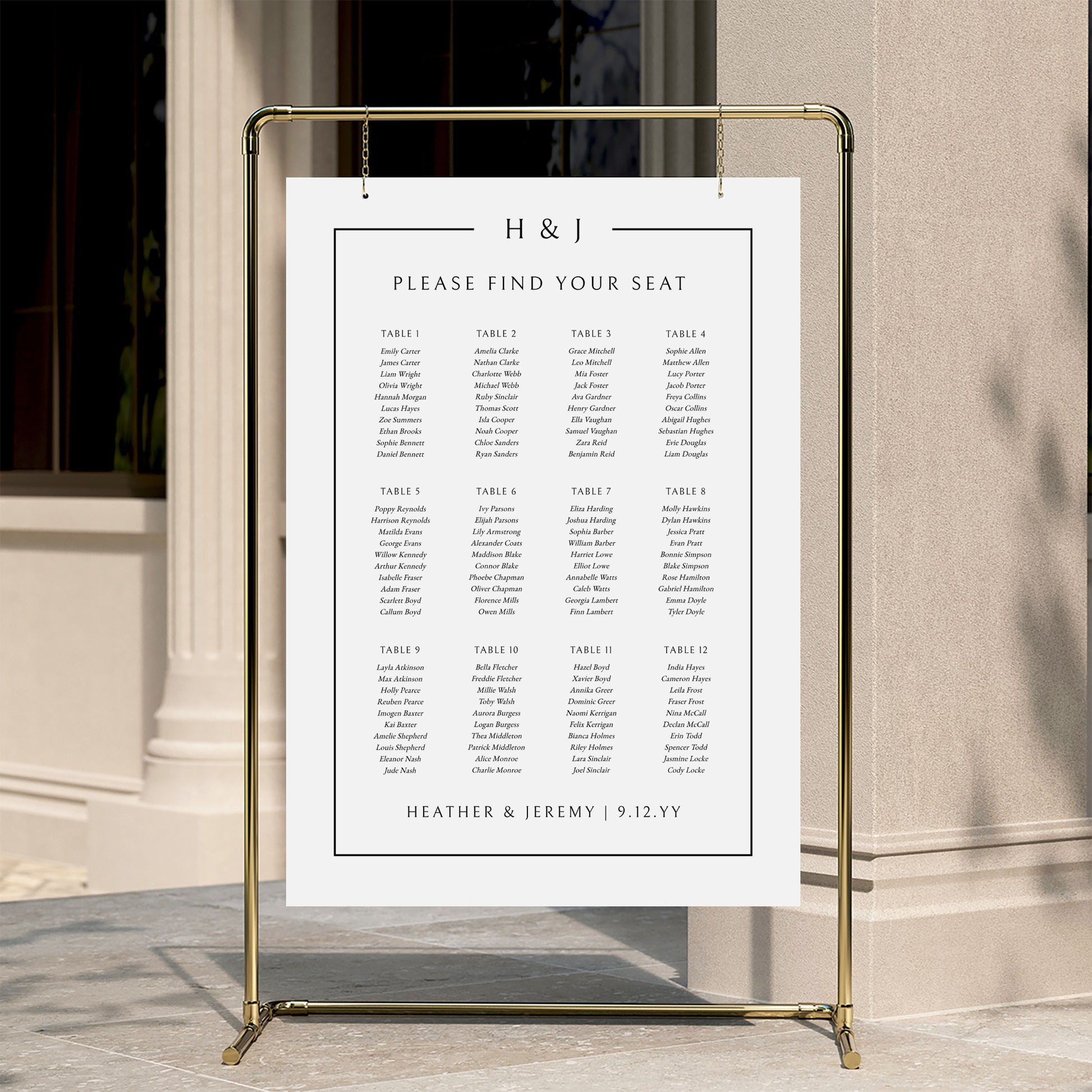 Elegant wedding seating chart template displayed on a gold stand against a neutral wall.