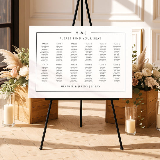 Modern seating chart template on an easel with floral arrangements and candles in a decorative setting.