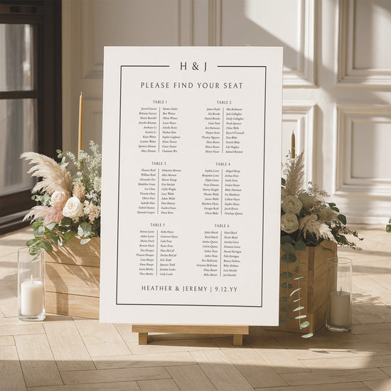 Elegant seating chart for a wedding with floral arrangements and candles in a room.