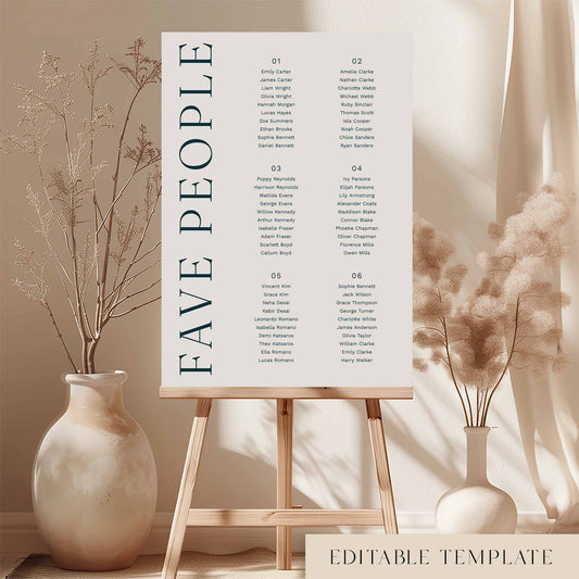 Modern 6-table micro wedding seating chart template on an easel with decorative vases and plants.