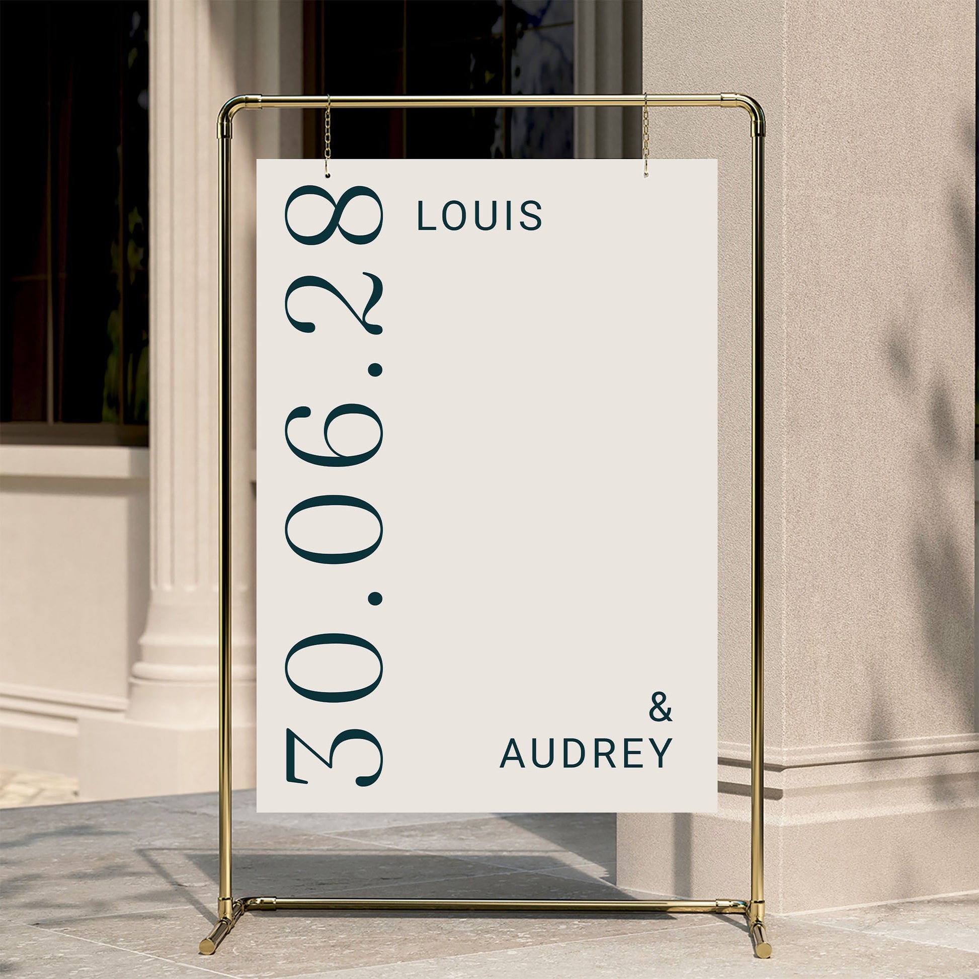 Editorial-inspired wedding welcome poster hanging from a gold pipe frame. This typographic Palais design features a chic cream and navy palette, perfect for a luxury outdoor reception. 