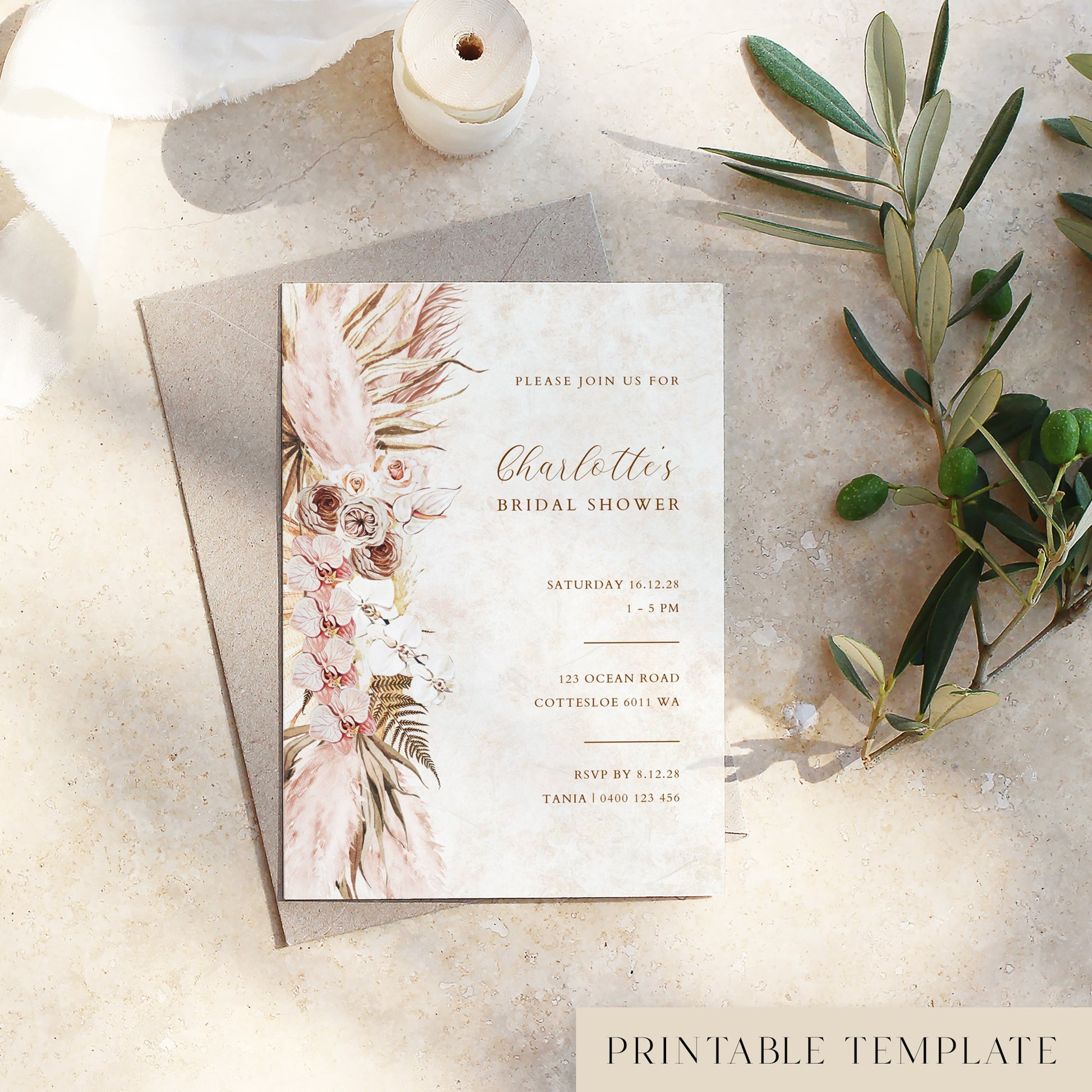 Bridal shower invitation card with pink floral design on a textured surface with olive branches.
