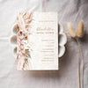 Bridal shower invitation template design on textured paper with dried flowers.