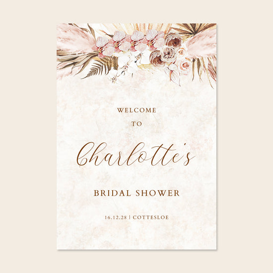 Bridal shower welcome sign with floral design and text on a beige background