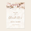 Bridal shower welcome sign with floral design and text on a beige background