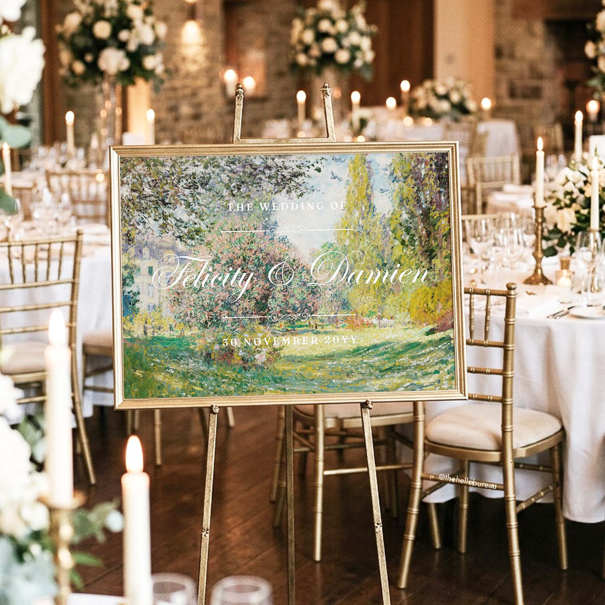 Framed Monet garden wedding sign on a gold easel, glowing among candlelit tables and white florals at an elegant reception.