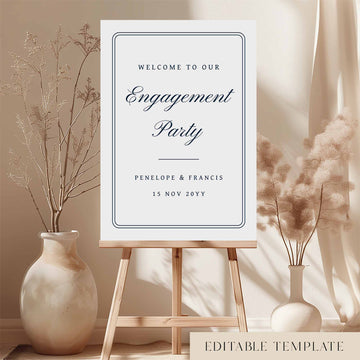 Engagement party welcome sign on an easel with decorative vases and plants.