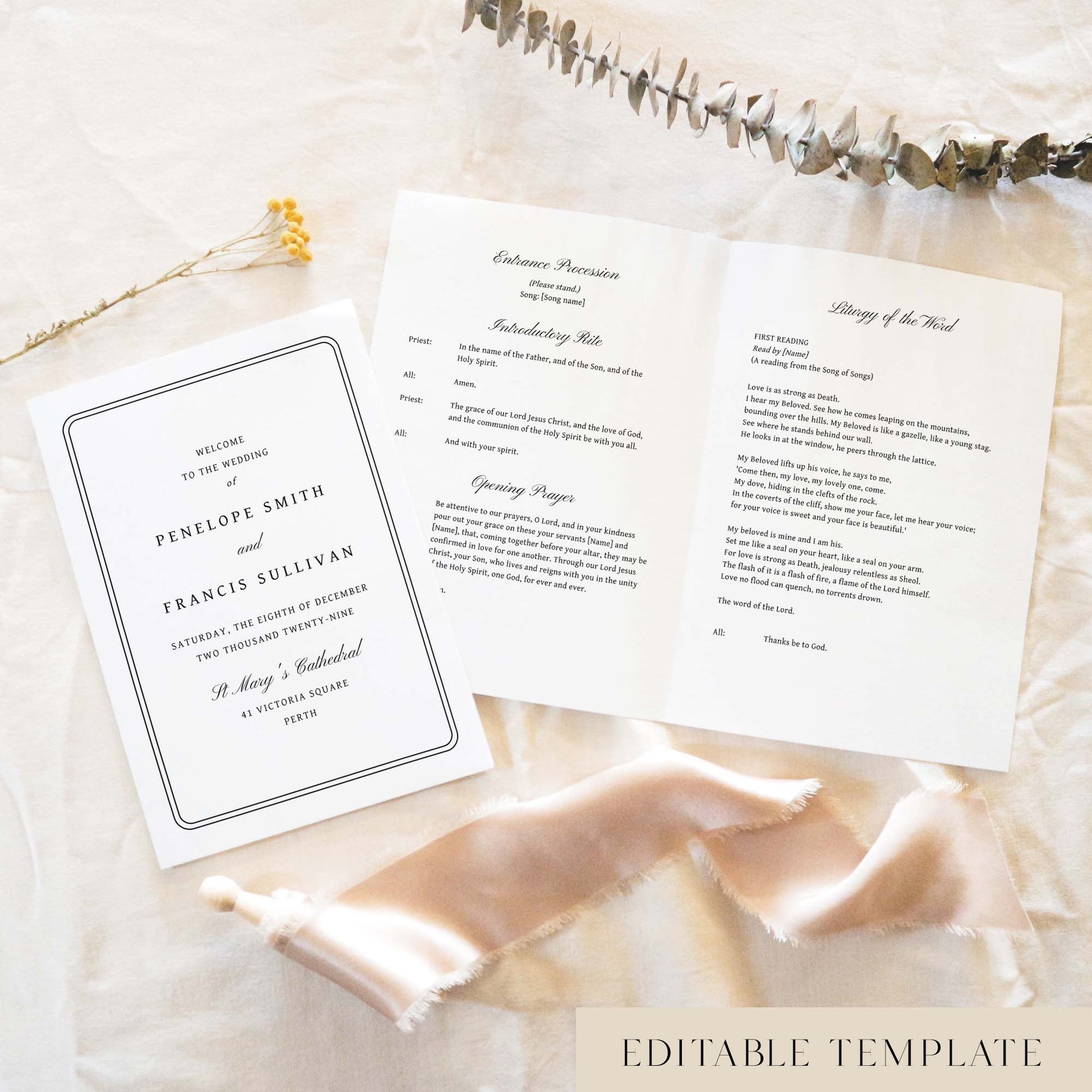 A5 wedding Mass ceremony booklet shown open with the cover beside it, styled on light fabric with dried florals and a soft ribbon.