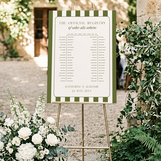 A vintage-inspired green stripe horseshoe seating chart on an easel, styled for a garden wedding entrance