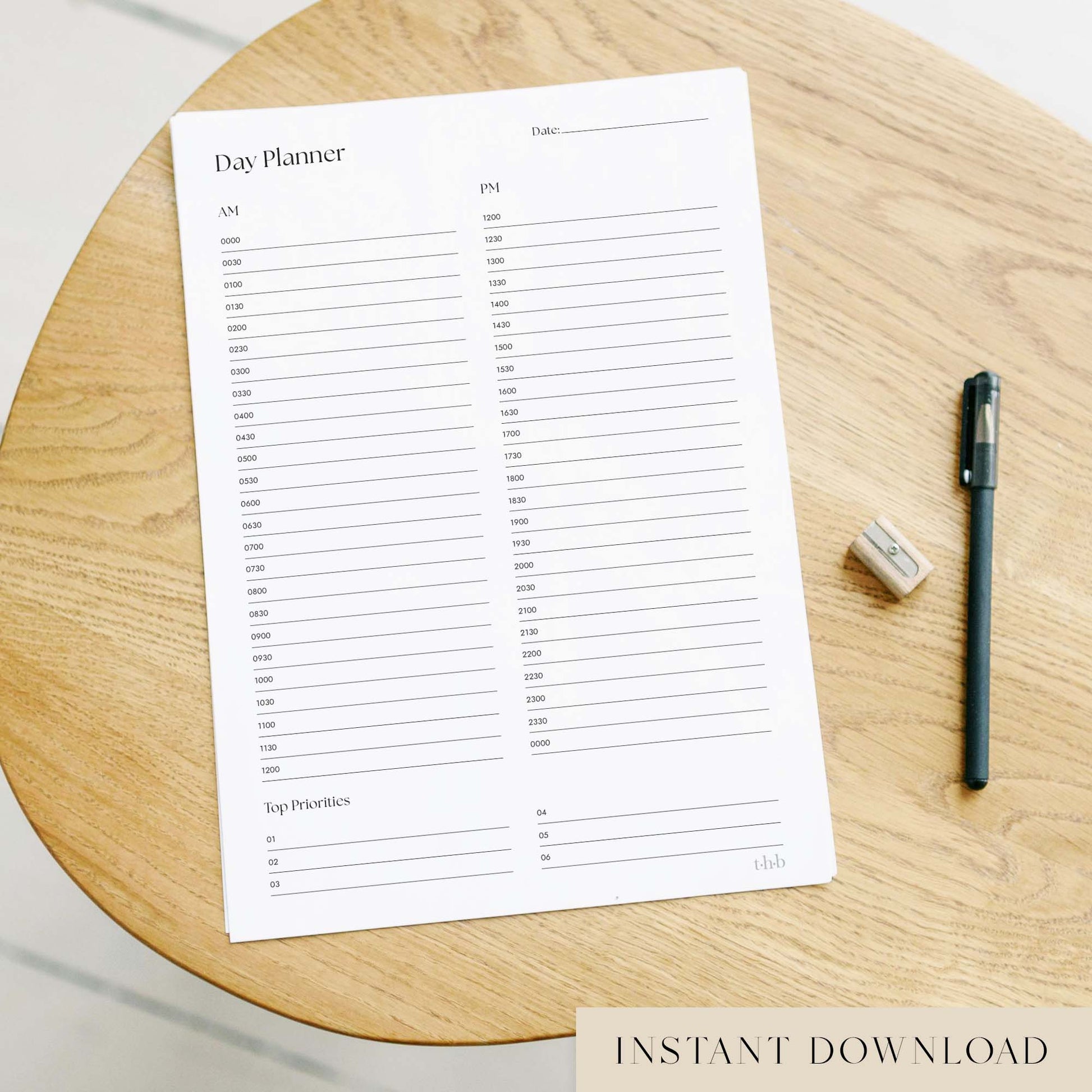 24-Hour day planner sheet on a wooden surface with a pen and eraser.