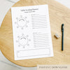 Printable A4 table seating planner on a wooden surface with a pen and eraser.