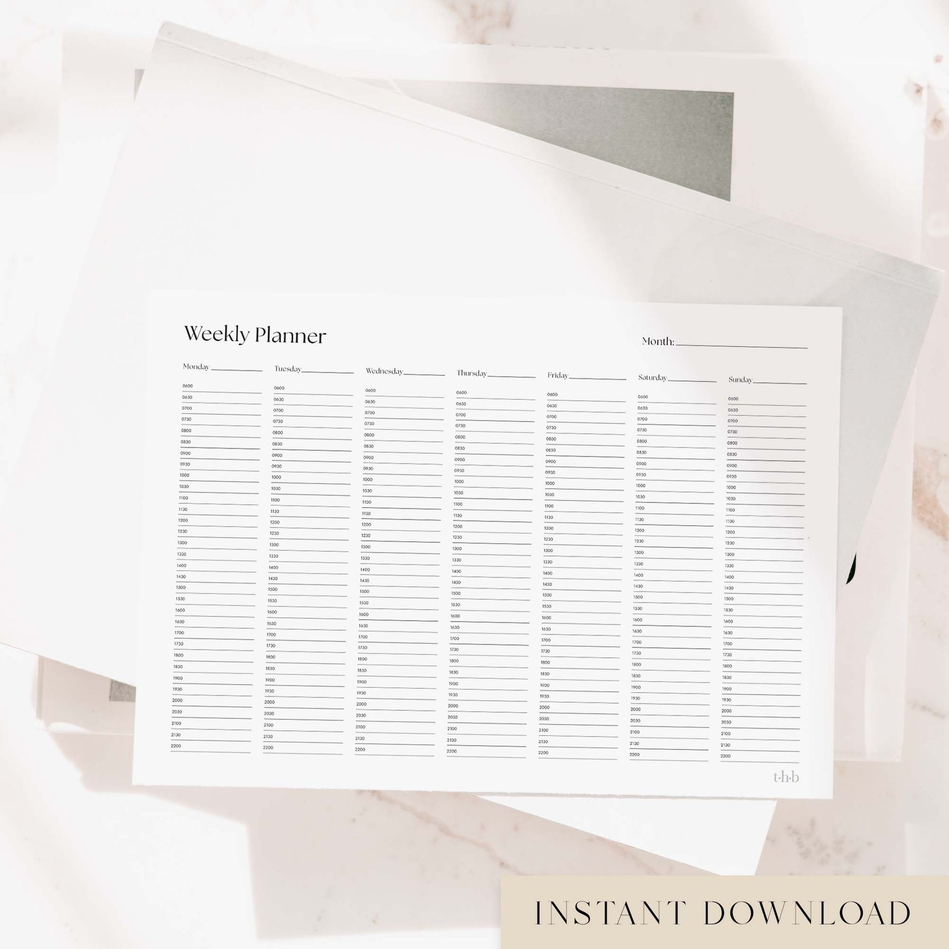 Printable weekly planner page on a stack of books.