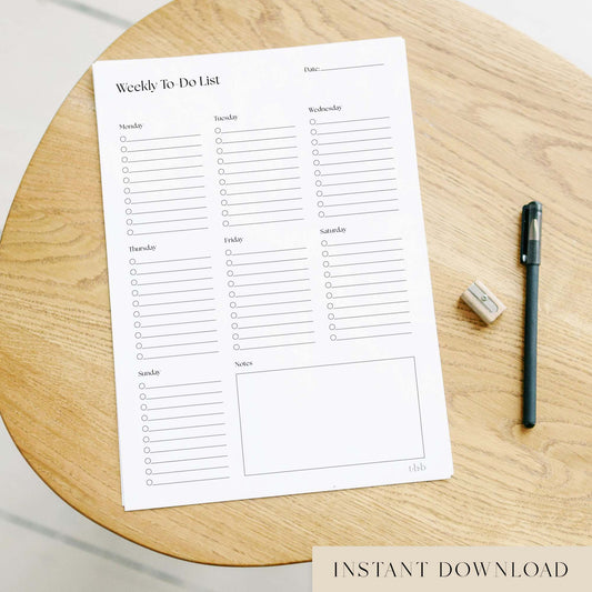 Printable weekly to-do list on a wooden surface with a pen and eraser.
