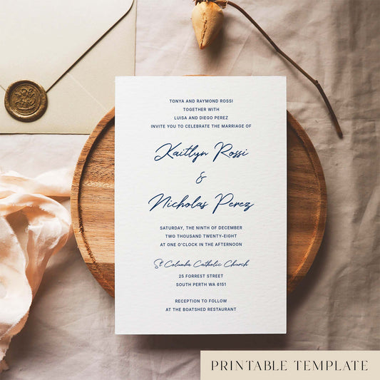 Modern wedding invitation template with traditional wording on a white card sitting on a wooden plate with decorative elements.