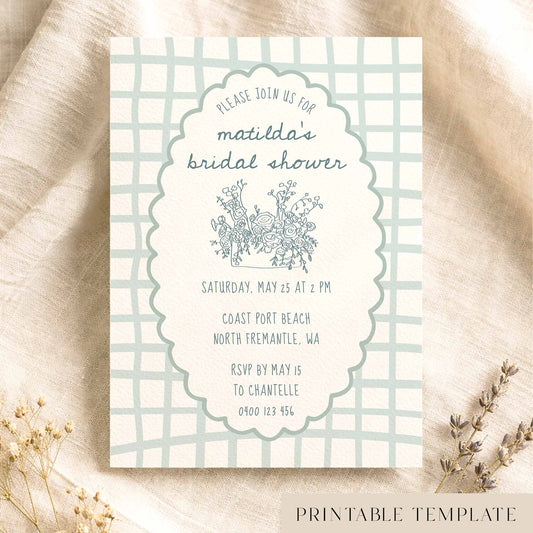 Whimsical blue bridal shower invitation template on textured card on fabric background.
