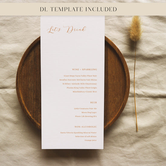 Bar menu card with drink options on a wooden plate with a dried plant, on a textured surface.