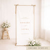 Gold frame with a hanging white linen wedding welcome sign.