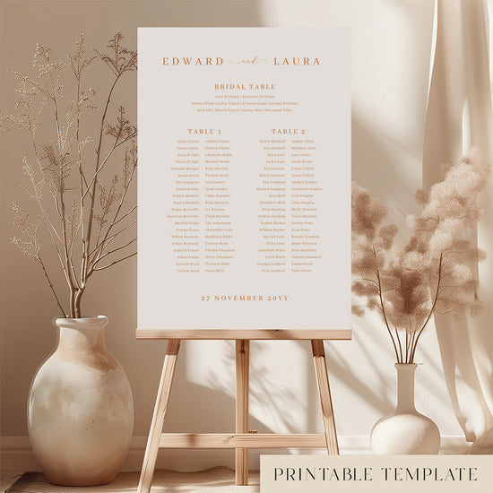 Printable minimal wedding seating chart sign on an easel with floral arrangements in a room setting.