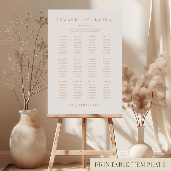 Printable minimal wedding seating chart sign on an easel with floral arrangements in a room setting.