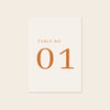Wedding printable table number template design on a beige background.