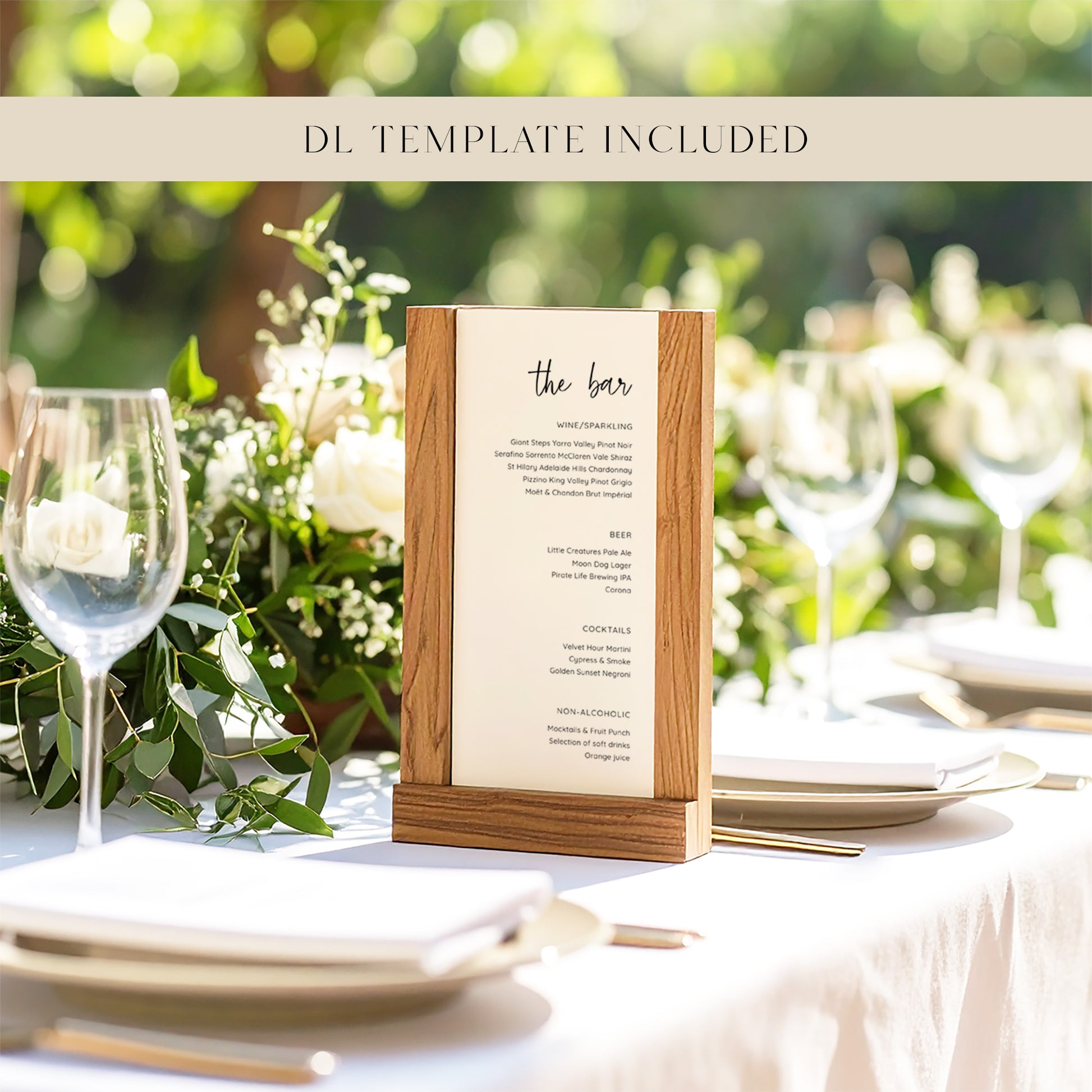 Table setting with a wooden menu holder displaying 'the bar' on a blurred natural background