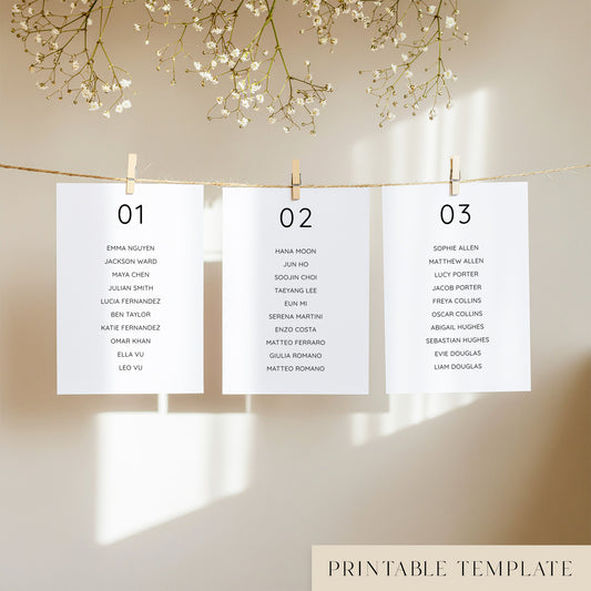 Three white seating chart cards with printed names, clipped to a string with pegs, against a neutral background.