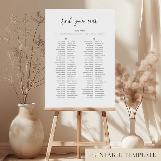 Printable minimal wedding seating chart sign on an easel with floral arrangements in a room setting.