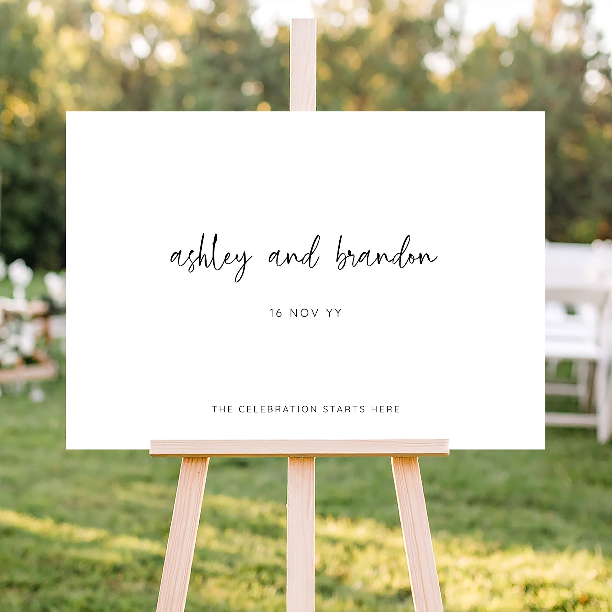 Horizontal wedding welcome sign on an easel with a blurred outdoor ceremony background.