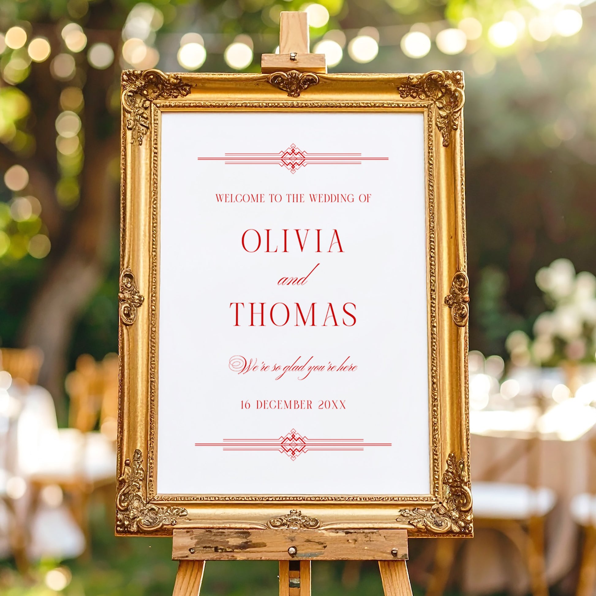 Old-money style wedding welcome sign template framed in ornate gold at an outdoor ceremony.