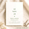 Minimal bridal shower invitation card on textured card on fabric background.