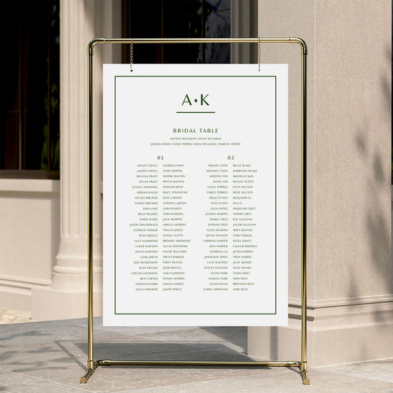Modern wedding seating chart template displayed on a gold stand against a neutral wall.