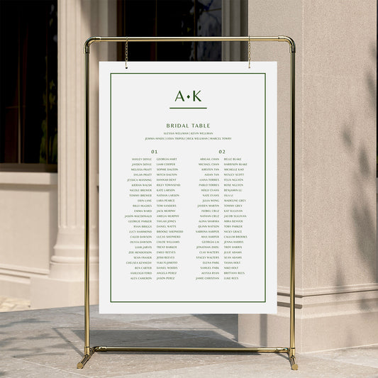 Modern wedding seating chart template displayed on a gold stand against a neutral wall.