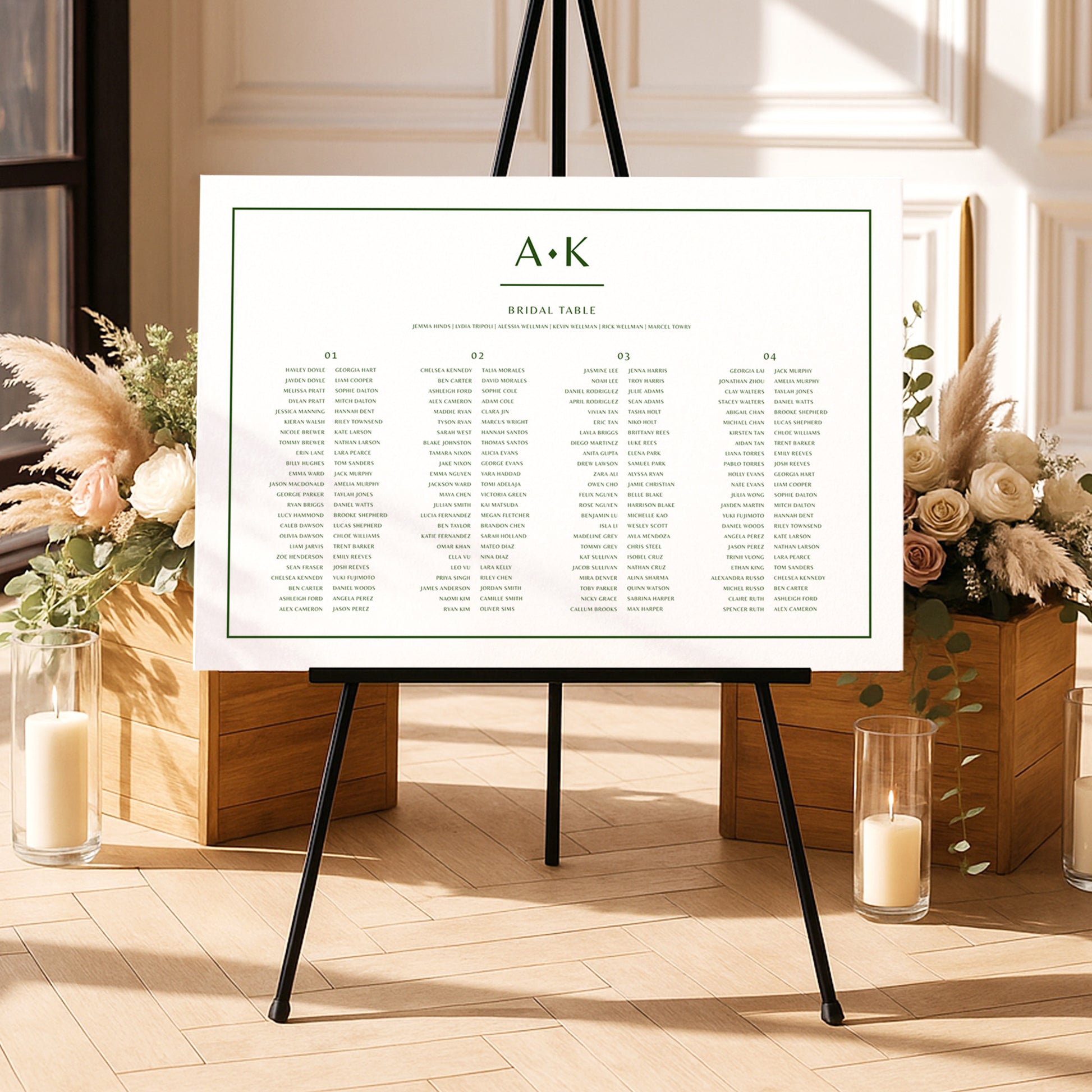 Modern long tables seating chart template on an easel with floral arrangements and candles in a decorative setting.