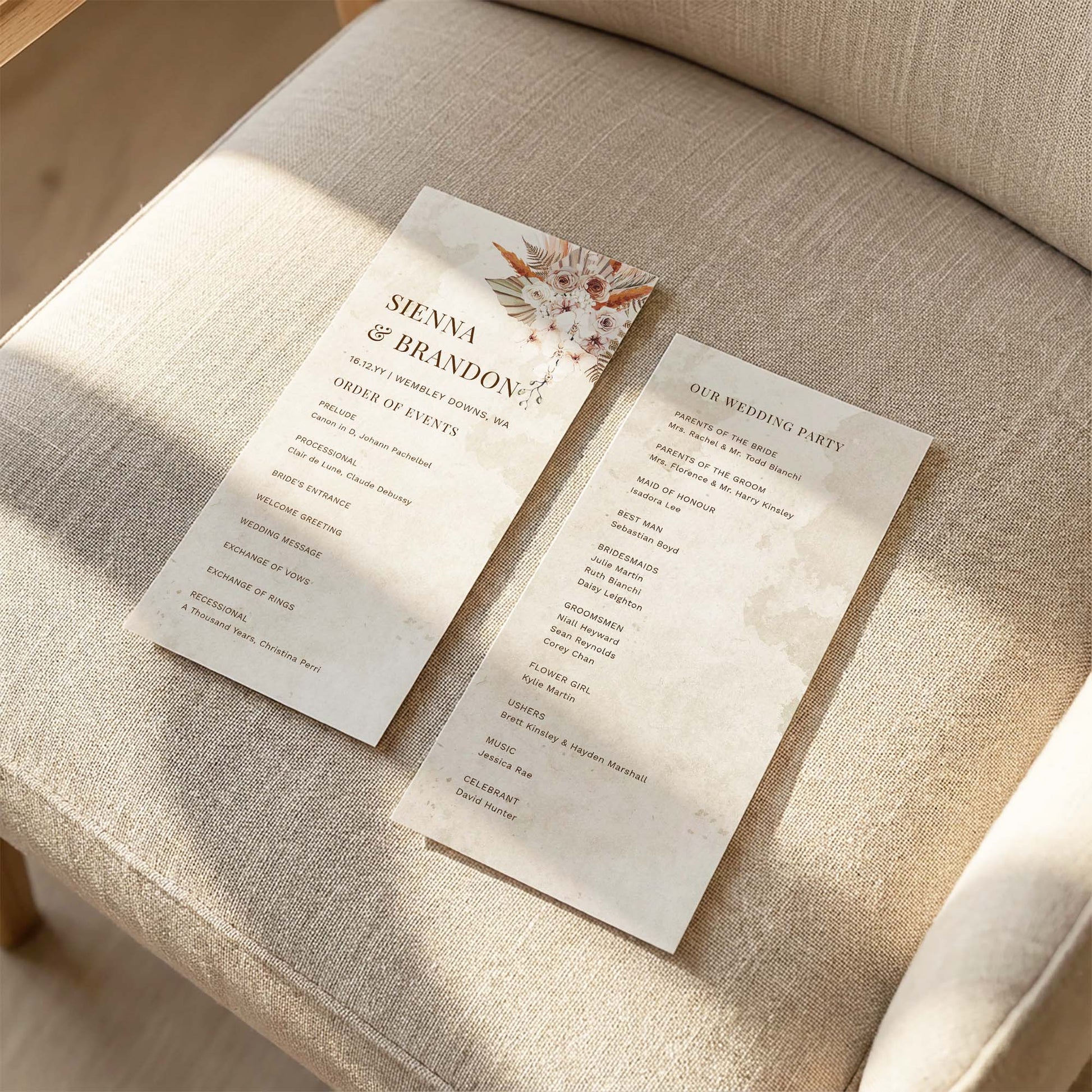 Printable boho wedding ceremony program template laid on a linen chair, double-sided DL size with desert floral design and order of events.