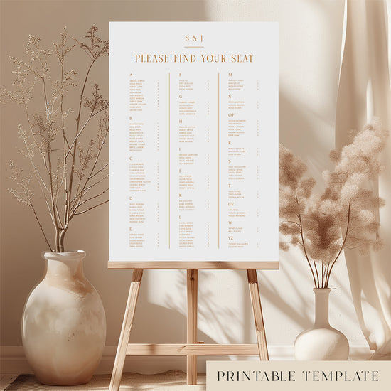 Printable elegant alphabetical wedding seating chart sign on an easel with floral arrangements in a room setting.
