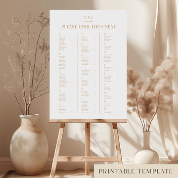 Printable elegant alphabetical wedding seating chart sign on an easel with floral arrangements in a room setting.