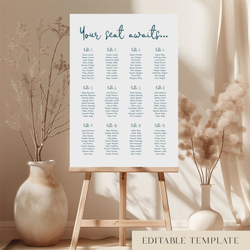 Whimsical round tables wedding seating chart template on a wooden easel with dried stems and neutral boho styling.