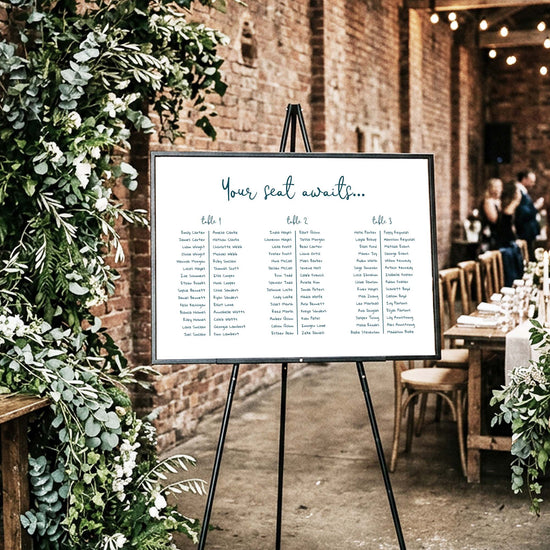 DIY whimsical 3 long tables wedding seating chart template styled at an indoor rustic venue.