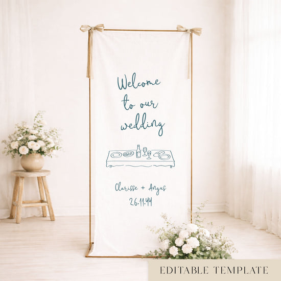 Gold frame with a hanging white whimsical linen wedding welcome sign.