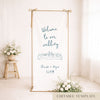 Gold frame with a hanging white whimsical linen wedding welcome sign.