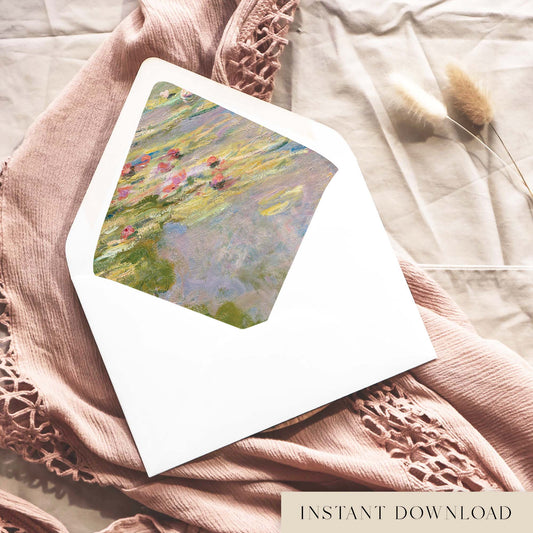 Printable Monet water lilies envelope liner for 5x7 wedding invitations, with painted pink lilies on lilac and blue pond water, shown inside a white envelope on dusty pink fabric.