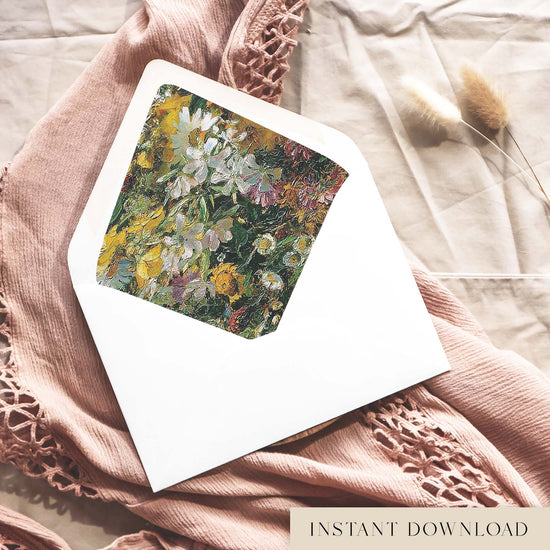Printable fine art floral envelope liner for 5x7 wedding invitations, with a painted yellow, white and green wildflower design, shown inside a white envelope on dusty pink fabric.